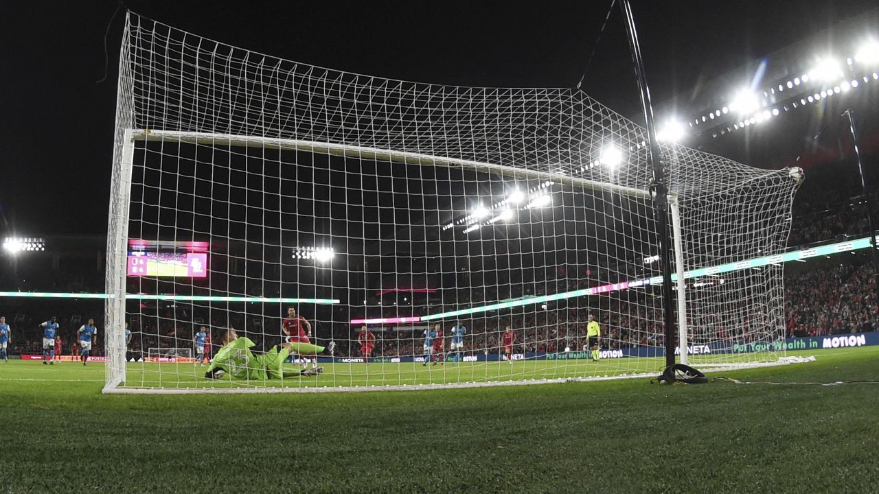Charlotte FC goalkeeper Pablo Sisniega, front left, is unable to stop a goal by St. Louis City SC midfielder Eduard Lowen, front right, during the first half of an MLS soccer match Saturday, March 4, 2023, in St. Louis. (AP Photo/Joe Puetz)