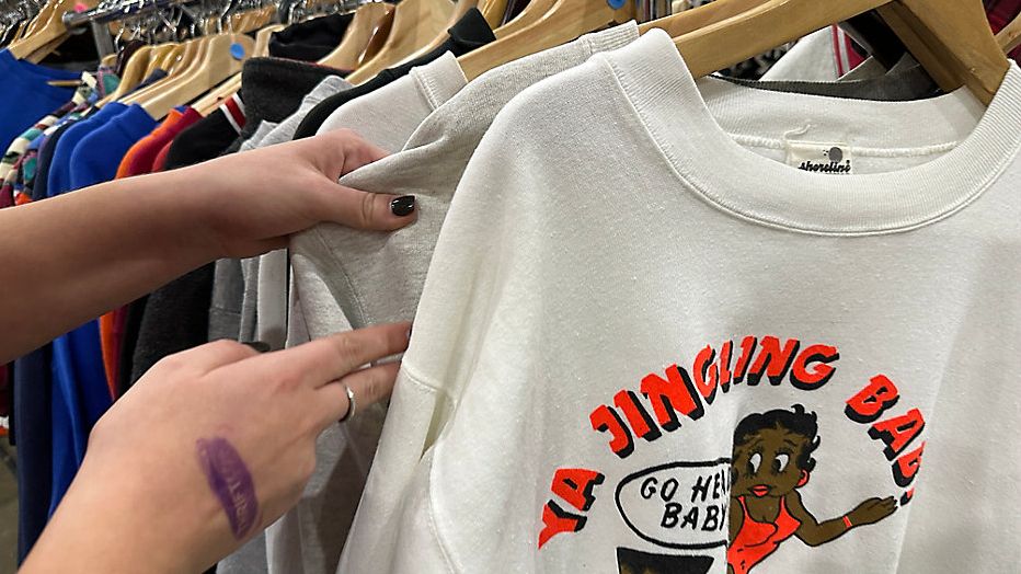 A shopper looks through racks at Thriftcon on Sunday at the Park Expo and Conference Center in Charlotte. (Spectrum News 1/Jordan Kudisch)