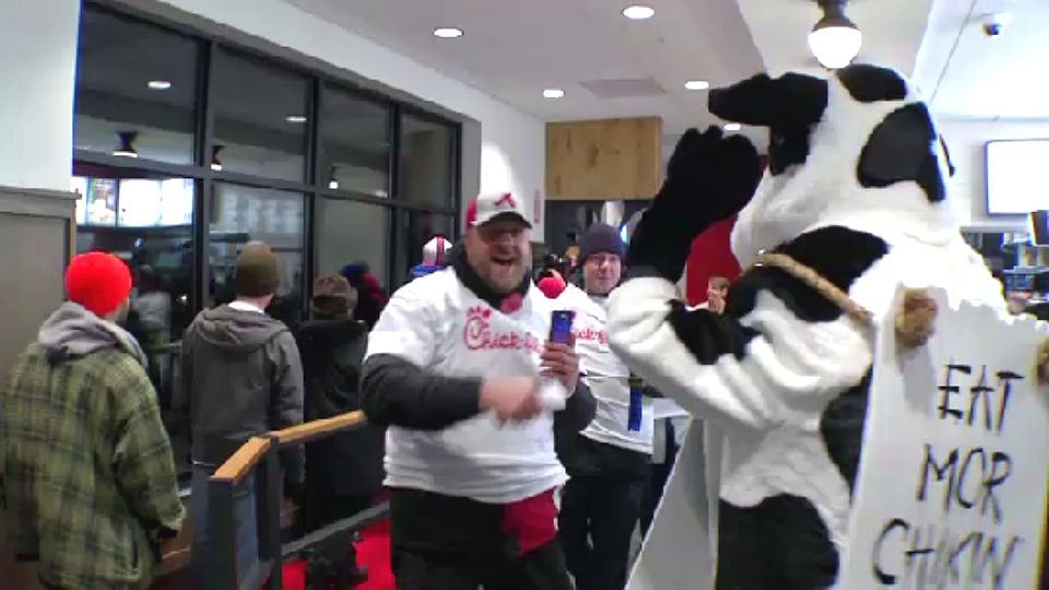 FILE photo of the Chick-fil-A mascot dressed as a cow with the sign "Eat Mor Chickin." 