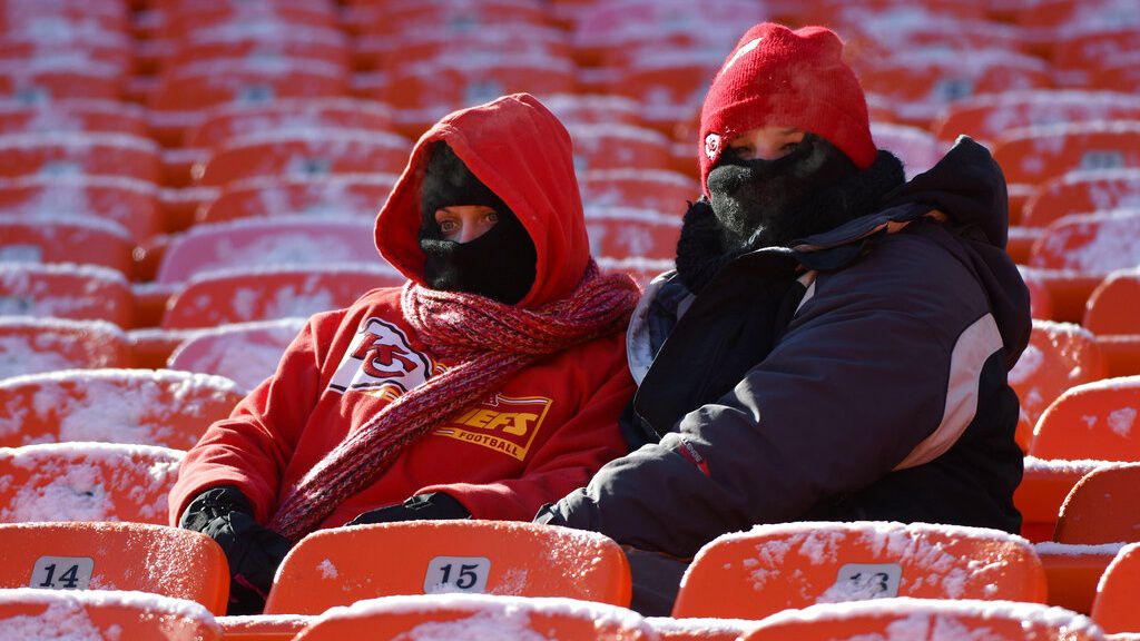 Two Kansas City Chiefs fans sit in the stands before an NFL football game against the Tennessee Titans in Kansas City, Mo., Sunday, Dec. 18, 2016. (AP Photo/Ed Zurga)