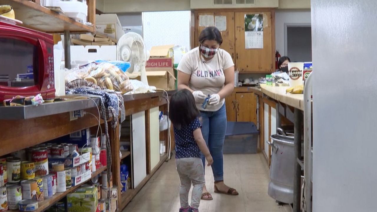 a mom and her kid in a kitchen