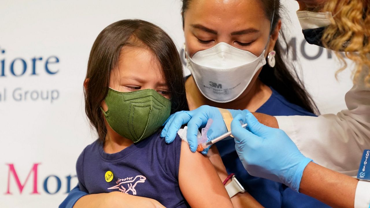 Maria Assisi holds her daughter Mia, 4, as a nurse administers the first dose of the Moderna COVID-19 vaccine for children 6 months through 5 years old on June 21 at Montefiore Medical Group in the Bronx borough of New York. (AP Photo/Mary Altaffer, File) 