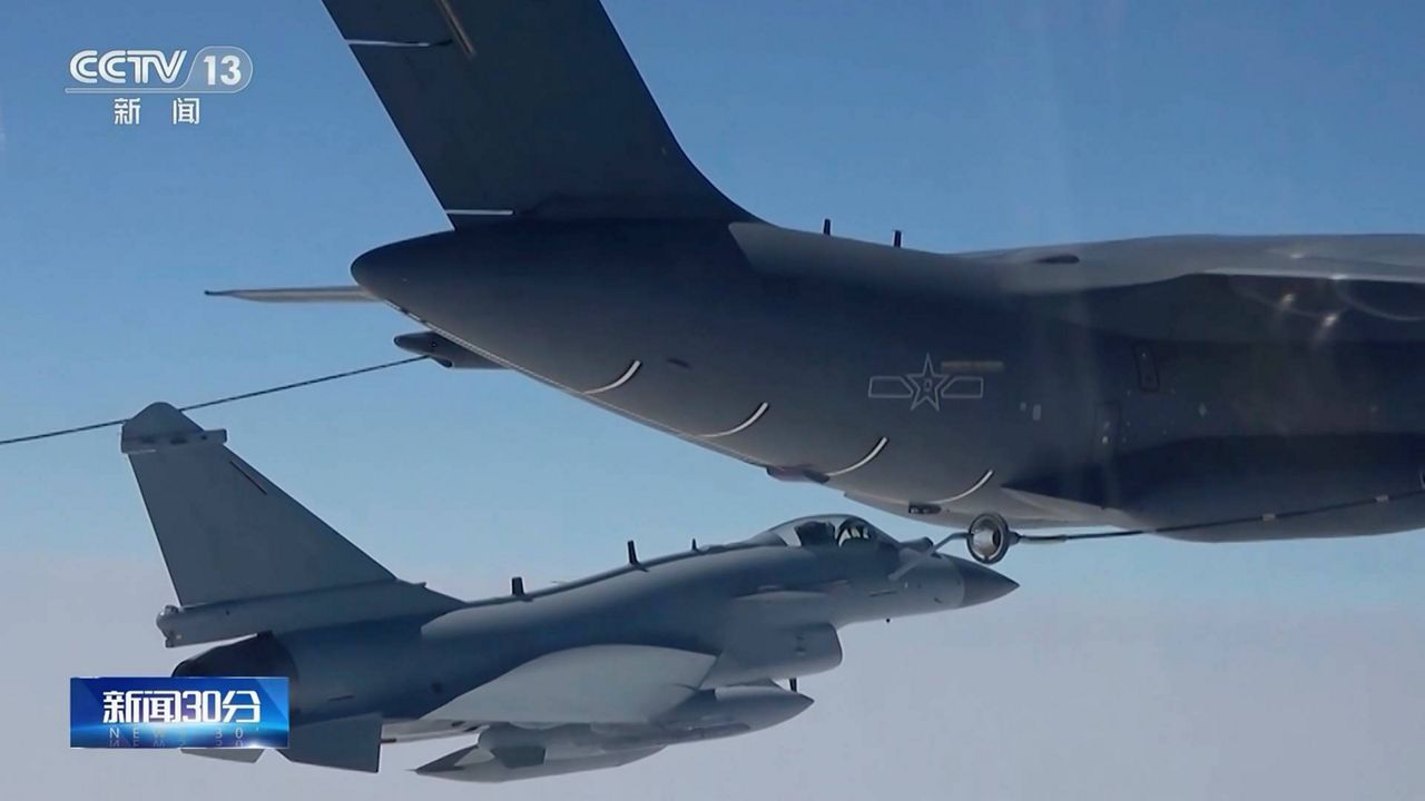 In this image taken from video footage run Saturday, April 8, 2023 by China's CCTV, a Chinese fighter jet performs an mid-air refueling maneuver at an unspecified location. The Chinese military announced exercises around Taiwan on Saturday in a new act of retaliation for a meeting between the U.S. House of Representatives speaker and the president of the self-ruled island democracy claimed by Beijing as part of its territory. (CCTV via AP)