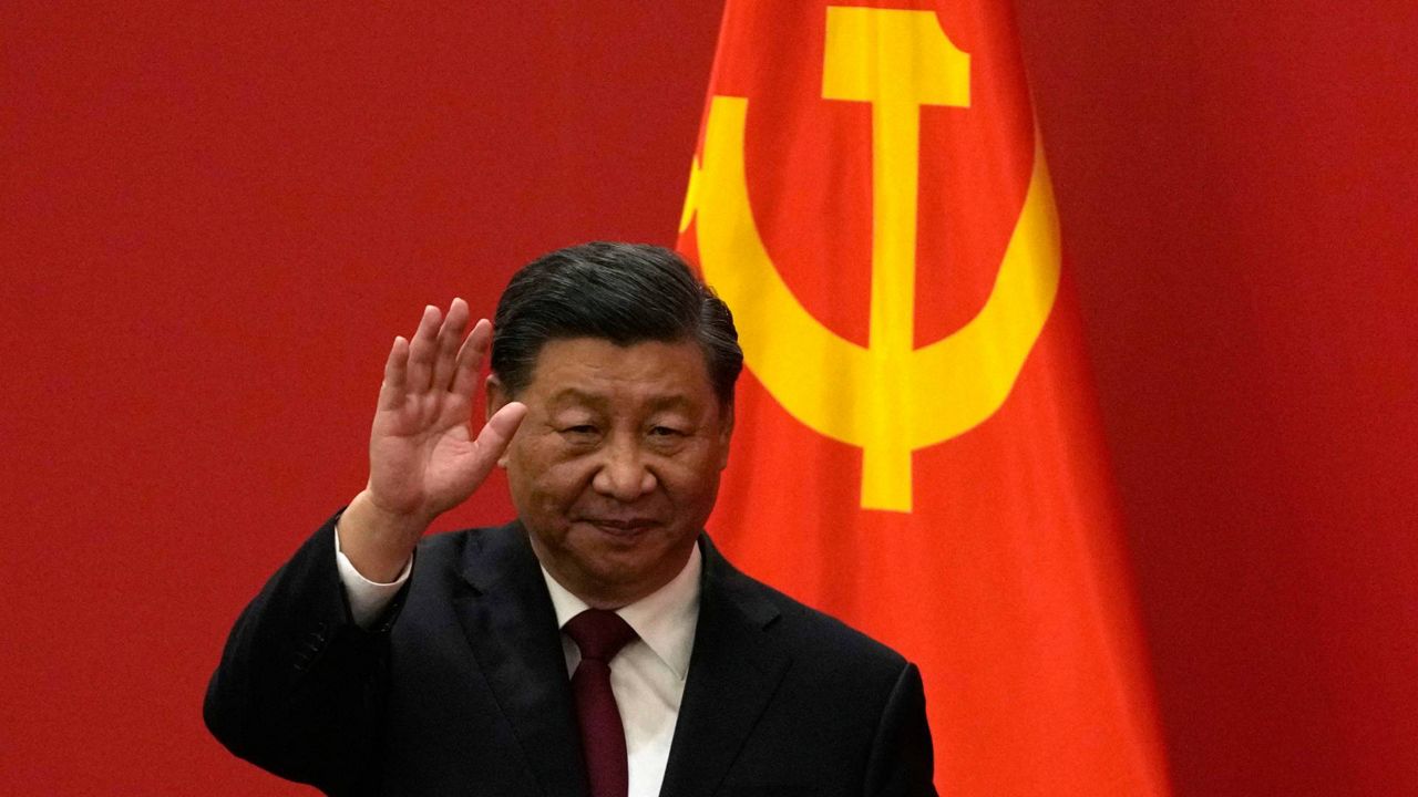 Chinese President Xi Jinping waves at an event to introduce new members of the Politburo Standing Committee at the Great Hall of the People in Beijing on Sunday. (AP Photo/Andy Wong)