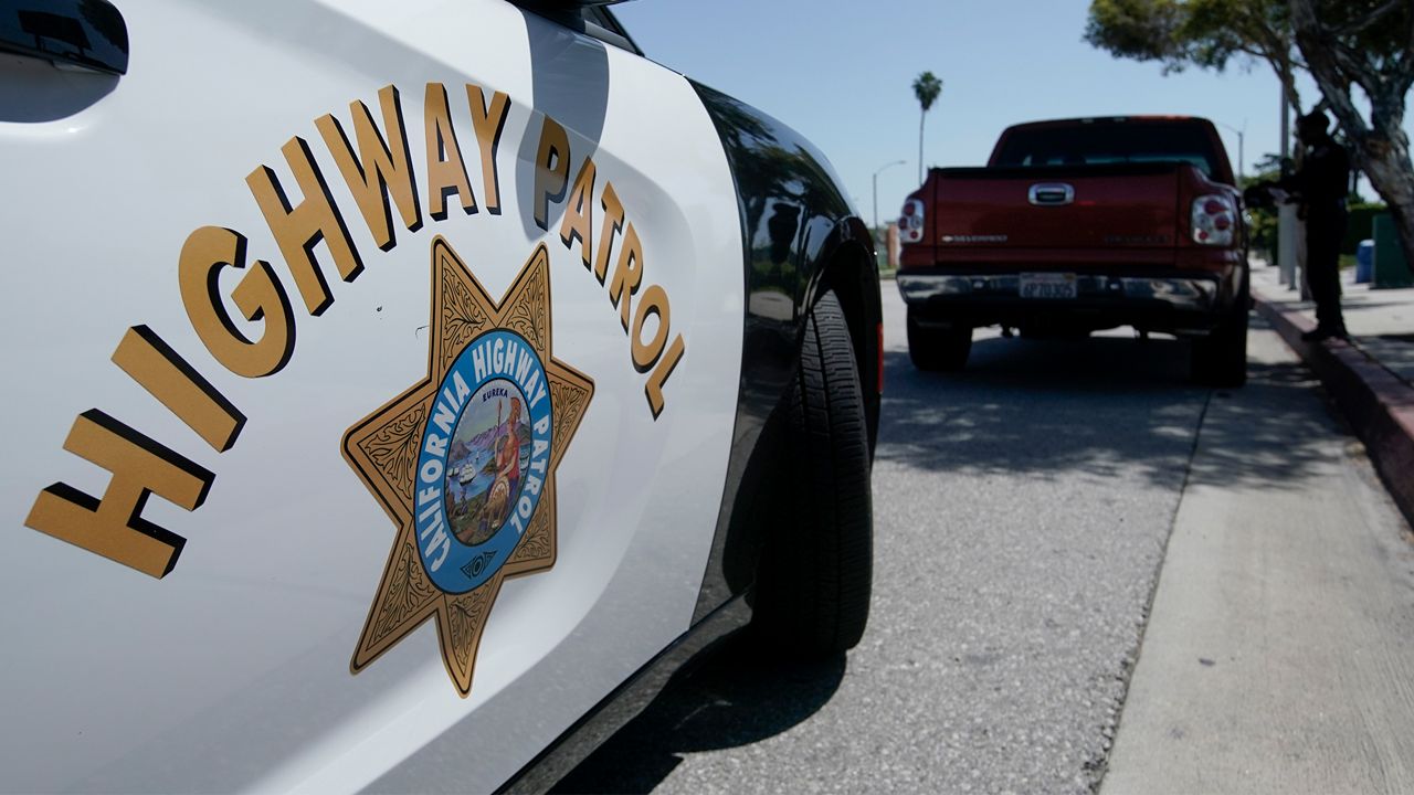 California Highway Patrol officer Duane Graham stops a motorist along Interstate 5 who is suspected of speeding Thursday, April 23, 2020, in Anaheim, Calif. The CHP is issuing a lot more tickets to motorists where lanes are wide open during the coronavirus pandemic. From March 19, when the stay-at-home order began, through April 19, officers issued 87% more citations to drivers suspected of speeding in excess of 100 mph. That's compared to the same period last year. The jump in speeding tickets coincides with a 35% decline in traffic volume. (AP Photo/Chris Carlson)