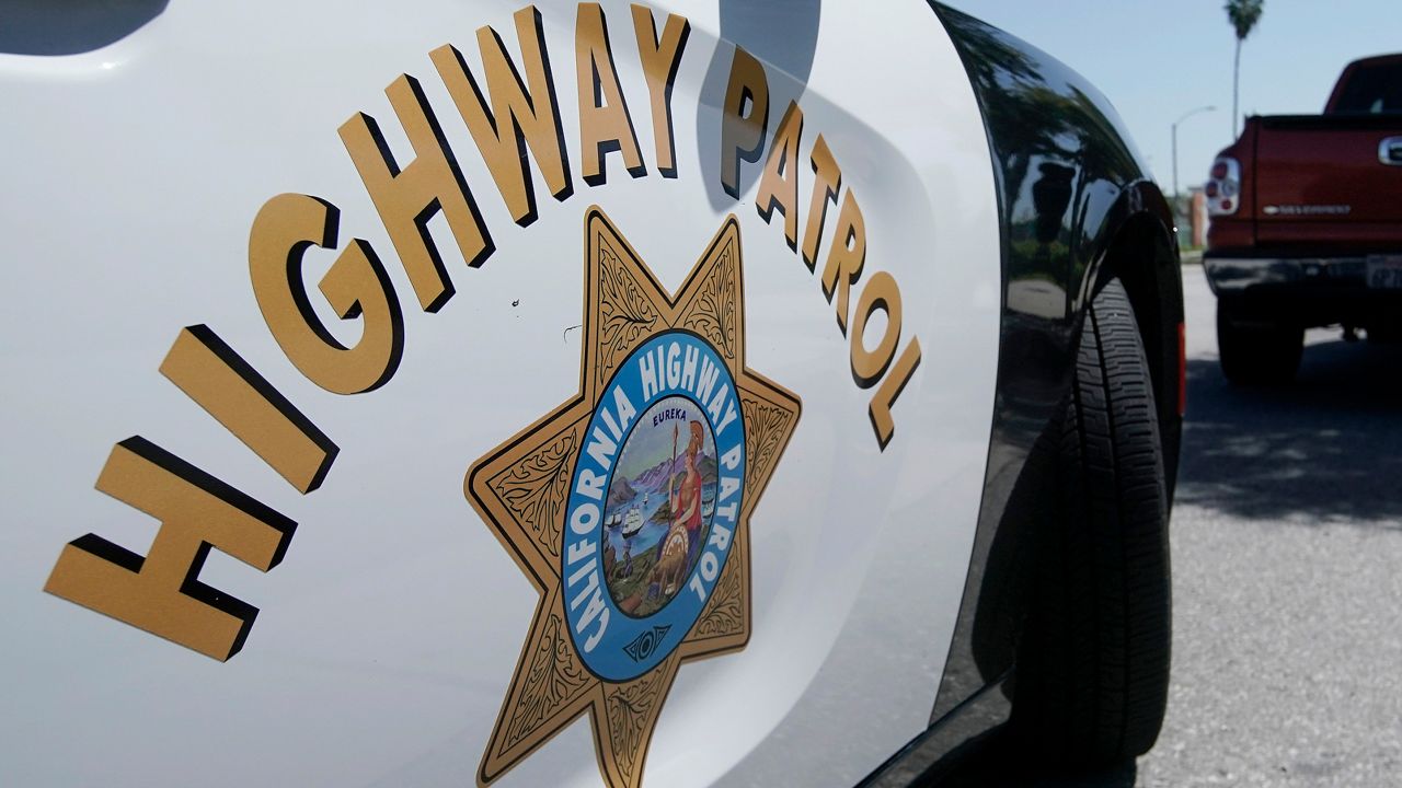 In this April 23, 2020, file photo, a California Highway Patrol officer stops a motorist in Anaheim, Calif. (AP Photo/Chris Carlson, File)