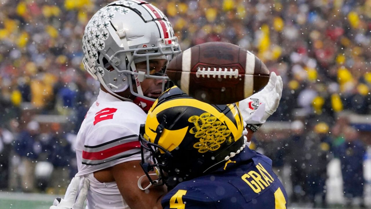Michigan defensive back Vincent Gray (4) breaks up a pass intended for Ohio State wide receiver Chris Olave (2) during the first half of an NCAA college football game, Saturday, Nov. 27, 2021, in Ann Arbor, Mich. (AP Photo/Carlos Osorio)