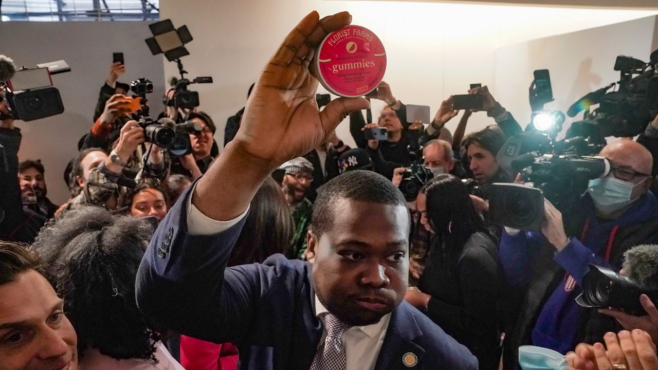 Chris Alexander shows off the first purchase of cannabis gummies bought at New York's first legal cannabis dispensary during a press conference on Thursday Dec. 29, 2022.