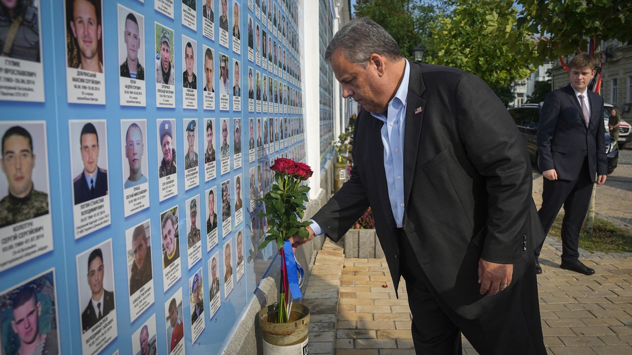 Republican presidential candidate and former New Jersey Gov. Chris Christie lays flowers Friday at the Wall of Remembrance in Kyiv, Ukraine, to pay tribute to Ukrainian soldiers killed. (AP Photo/Efrem Lukatsky)