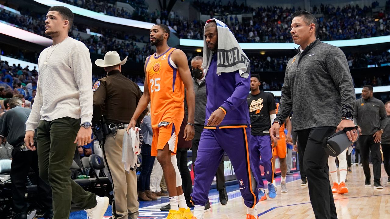 Phoenix Suns forward Mikal Bridges (25) and guard Chris Paul, second from right, walk off the court after Game 4 of an NBA basketball second-round playoff series against the Dallas Mavericks, Sunday, May 8, 2022, in Dallas. (AP Photo/Tony Gutierrez)