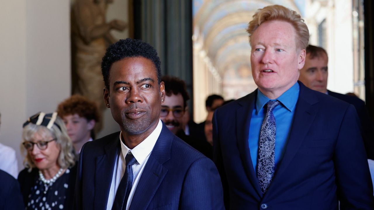 Chris Rock, left, and Conan O'Brien arrive for an audience with Pope Francis in the Clementine Hall at The Vatican on Friday. (AP Photo/Riccardo De Luca)