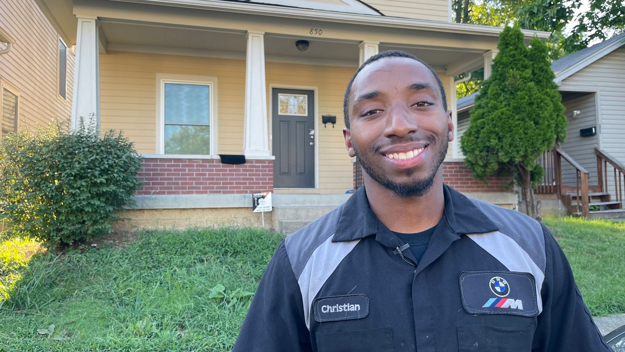 First time homeowner Christian Davis outside his two-story home in Louisville’s West End (Spectrum News 1/Mason Brighton)