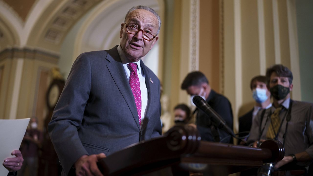 Senate Majority Leader Chuck Schumer speaks to reporters Tuesday at the Capitol as lawmakers work to advance the $1 trillion bipartisan infrastructure bill. (AP Photo/J. Scott Applewhite)