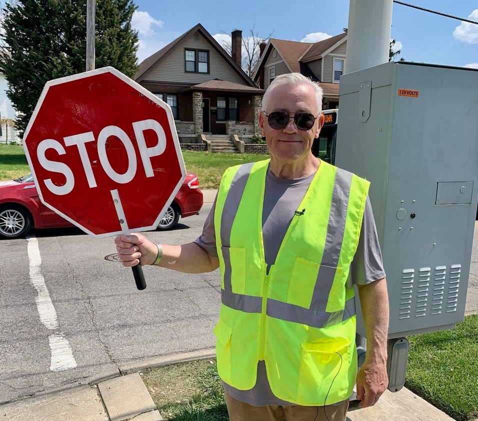 Crossing guard Bill Cole stands outside Midway Elementary. (Photo courtesy of City of Cincinnati)