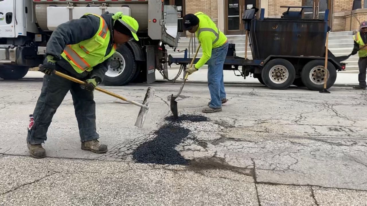 City of Cincinnati employees repair a pothole. (Spectrum News 1)