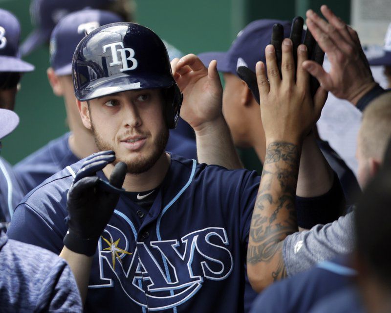 Tampa Bay Rays designated hitter C.J. Cron is congratulated by teammates after hitting a solo home run off Kansas City Royals starting pitcher Jason Hammel during the third inning of a baseball game at Kauffman Stadium in Kansas City, Mo., Wednesday, May 16, 2018. (AP Photo/Orlin Wagner)