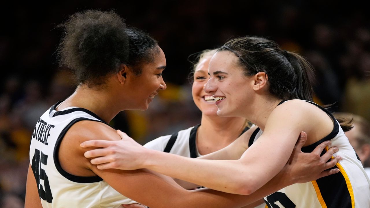 Iowa forward Hannah Stuelke, left, celebrates with teammate guard Caitlin Clark, right, at the end of an NCAA college basketball game against Penn State, Thursday, Feb. 8, 2024, in Iowa City, Iowa.