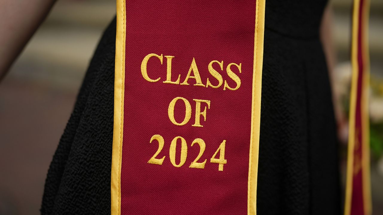 A recent graduate wears a garment with their graduation year on the University of Southern California campus Thursday, April 25, 2024, in Los Angeles. (AP Photo/Jae C. Hong)