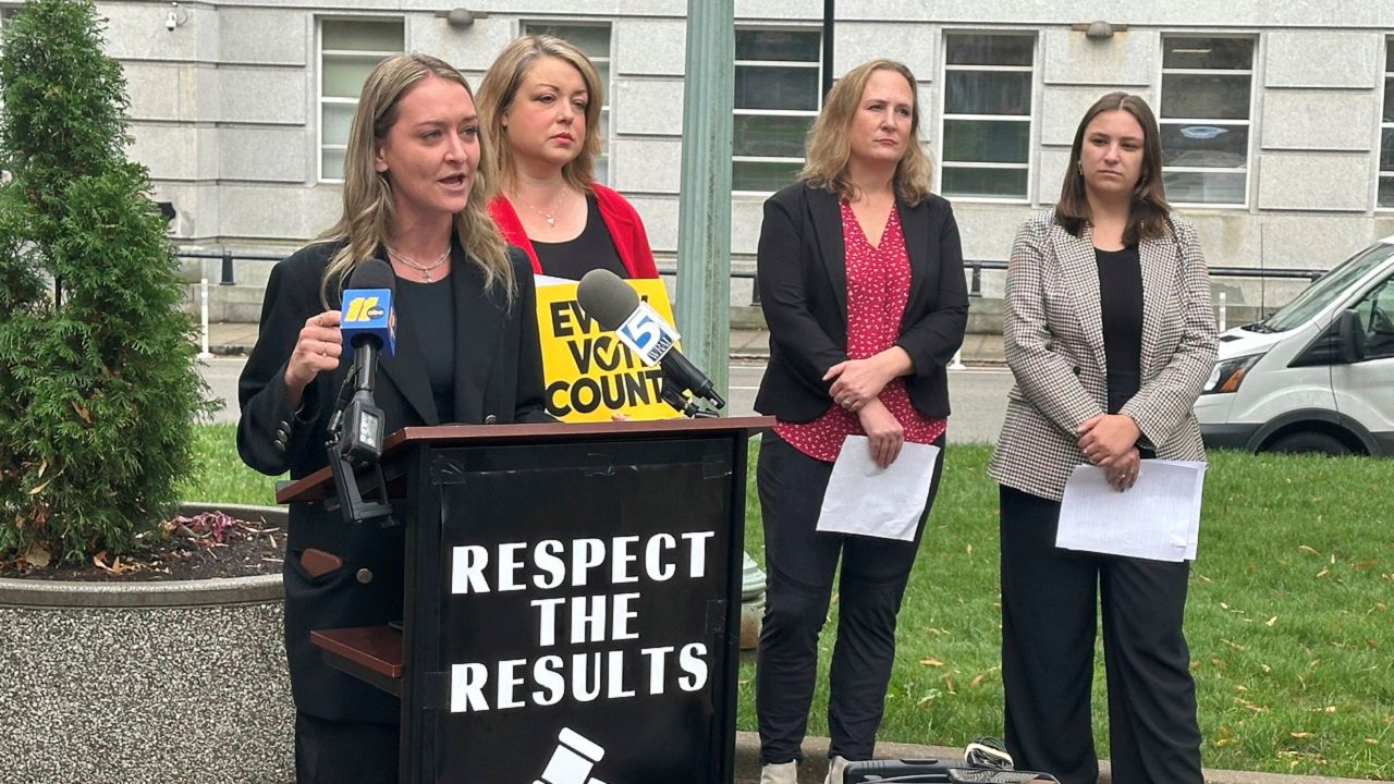 North Carolina state Democratic Party Chair Anderson Clayton, left, speaks at a news conference about the pending election for a state Supreme Court seat on Tuesday, Dec. 10, 2024, on Capitol Square in Raleigh, N.C. (AP Photo/Gary D. Robertson)