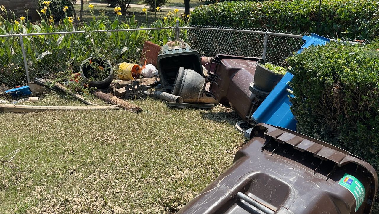 Floodwaters from Tropical Storm Chantal on Sunday pushed plants, trash bins and debris around the property of Kendra Lewis' family in Durham County. (Spectrum News 1/Jatrissa Wooten)