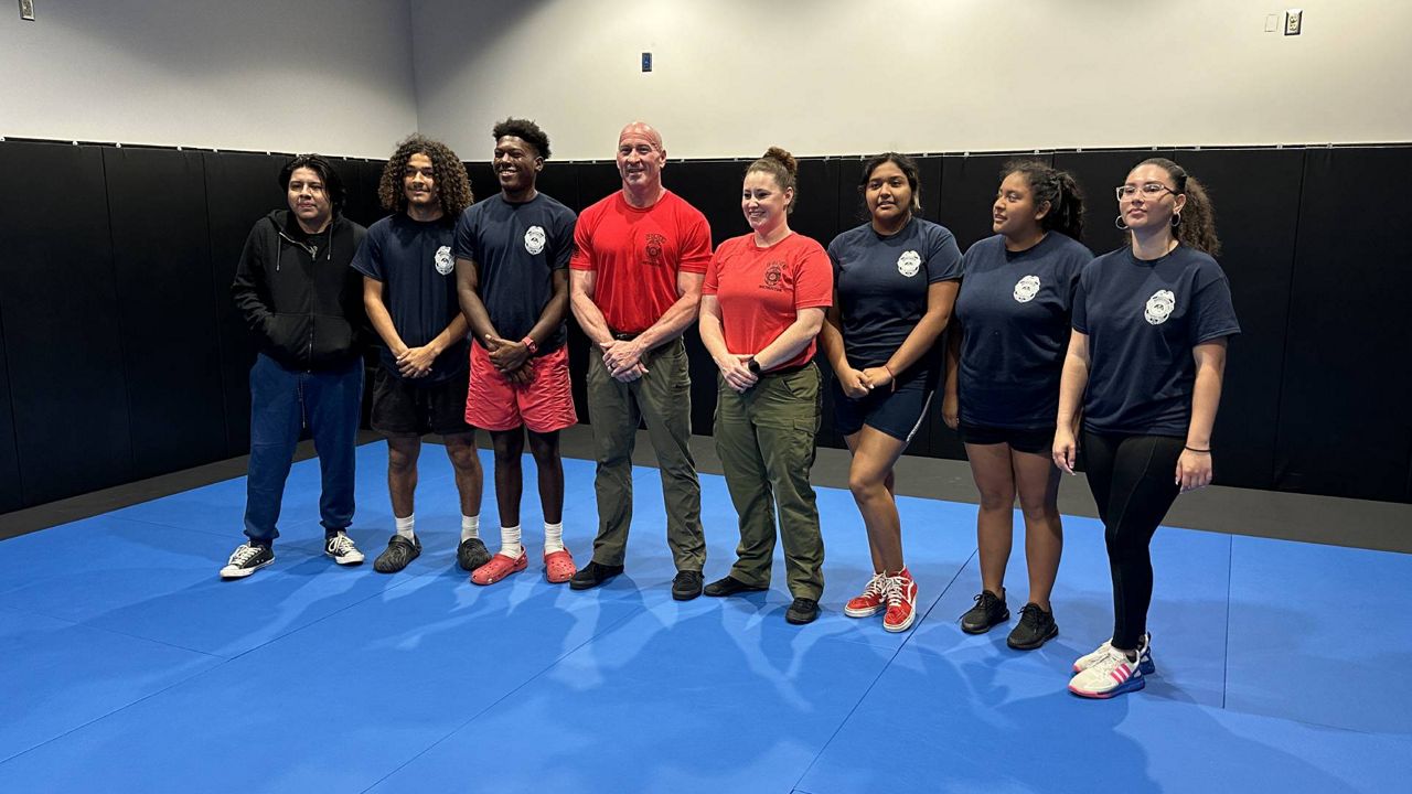 Graduates of the police academy pose for a photo. (Spectrum Bay News 9/Fallon Silcox)