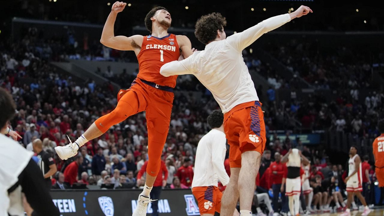 Clemson guard Chase Hunter (1) and forward Daniel Nauseef (32) celebrate after a win over Arizona in a Sweet 16 college basketball game in the NCAA tournament Thursday, March 28, 2024, in Los Angeles. (AP Photo/Ryan Sun)