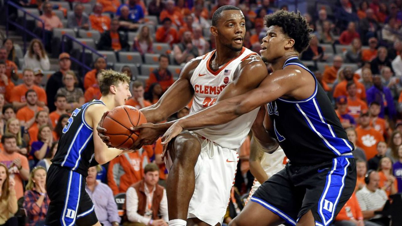 Clemson's Aamir Simms grabs a rebound while defended by Duke's Vernon Carey Jr. during the first half of an NCAA college basketball game Tuesday, Jan. 14, 2020, in Clemson, S.C.