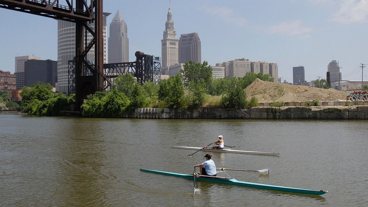 Two rowers paddle along the Cuyahoga River in Cleveland on July 12, 2011.