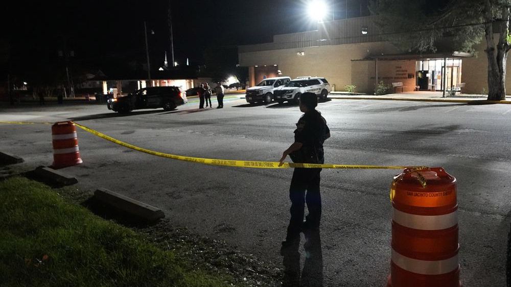 A law enforcement officer stands at the perimeter set outside the San Jacinto County Jail after the suspected gunman in a mass shooting arrived Tuesday, May 2, 2023, in Coldspring, Texas. Francisco Oropewsa, who allegedly shot five of his neighbors, including a child, was captured Tuesday in Montgomery County and transferred to the jail Tuesday night. (AP Photo/David J. Phillip)