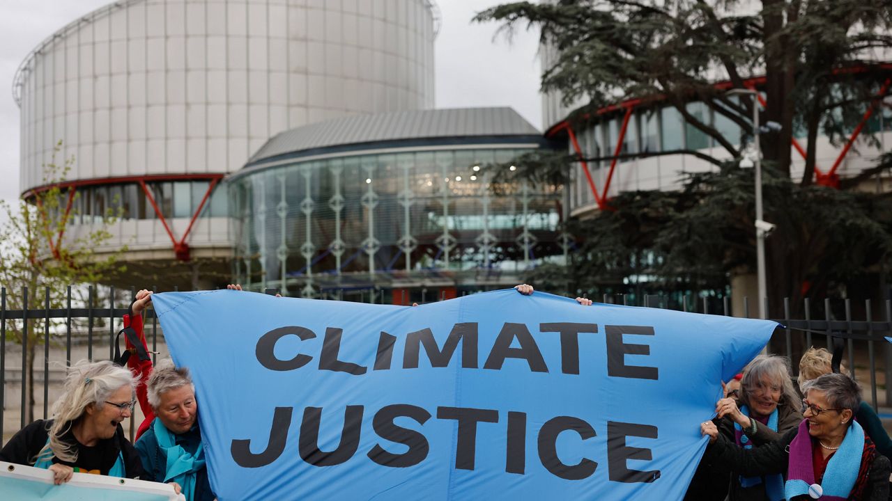 People demonstrate outside the European Court of Human Rights Tuesday, April 9, 2024 in Strasbourg, eastern France.  (AP Photo/Jean-Francois Badias)