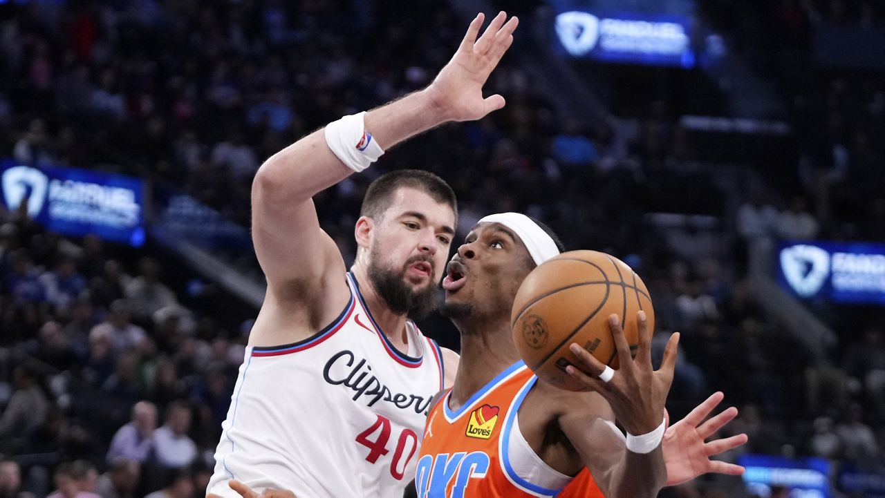 Oklahoma City Thunder guard Shai Gilgeous-Alexander, right, shoots as Los Angeles Clippers center Ivica Zubac defends during the first half of an NBA basketball game, Saturday, Nov. 2, 2024, in Inglewood, Calif. (AP Photo/Mark J. Terrill)