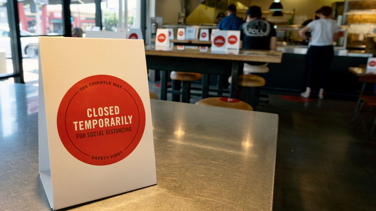 A temporary closed sign sections off a Chipotle restaurant for social distancing to protect from the coronavirus in Los Angeles on Monday, July 20, 2020. Mayor Eric Garcetti conceded Sunday that Los Angeles reopened too quickly and again warned that the city was "on the brink" of new shutdown orders as the coronavirus continues to surge in California. (AP Photo/Richard Vogel)