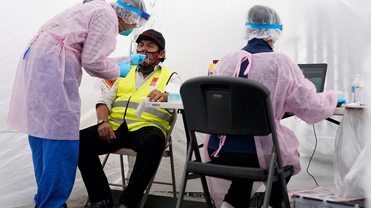 Many doctors are warning that people still need to wear masks and social distance. (File photo)