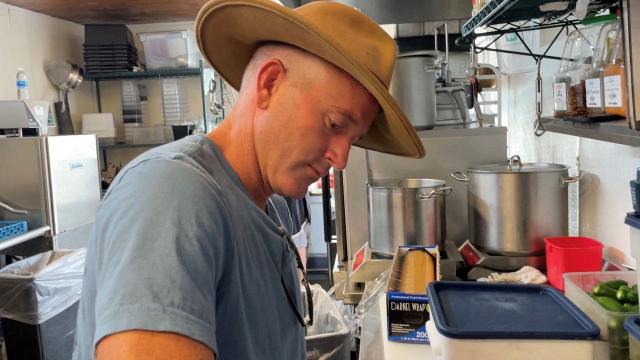 Cody Leutgens prepping salsa cups (Spectrum News 1/Alex Wilkinson)
