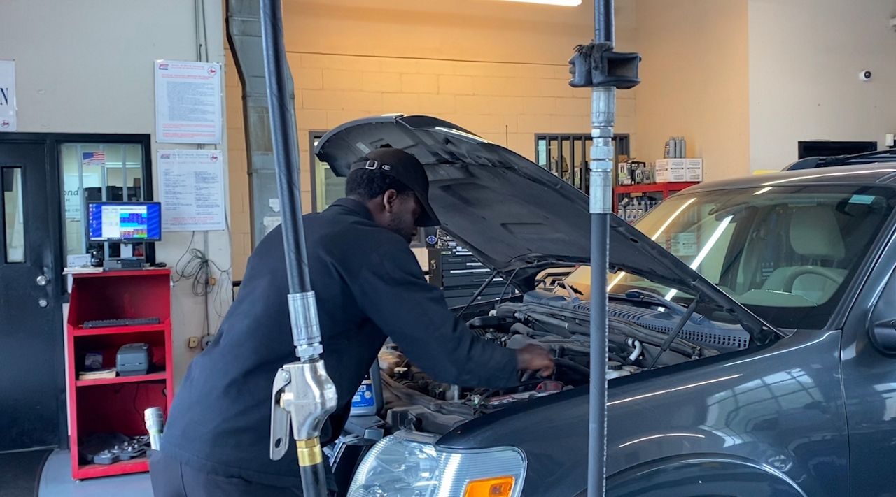 Damian Wright checks the car battery. 