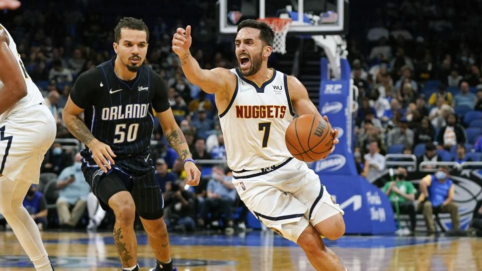 Denver Nuggets guard Facundo Campazzo (7) drives around Orlando Magic guard Cole Anthony (50) during the first half of an NBA basketball game, Wednesday, Dec. 1, 2021, in Orlando, Fla. (AP Photo/John Raoux)