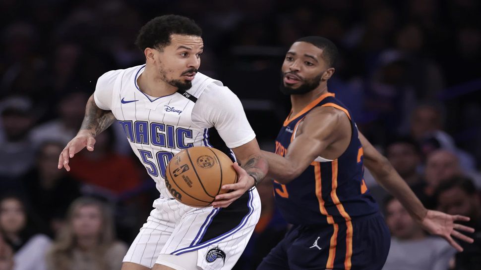 Orlando Magic guard Cole Anthony (50) drives against New York Knicks forward Mikal Bridges, right, during the first half of an NBA basketball game Monday, Jan. 6, 2025, in New York. (AP Photo/Adam Hunger)