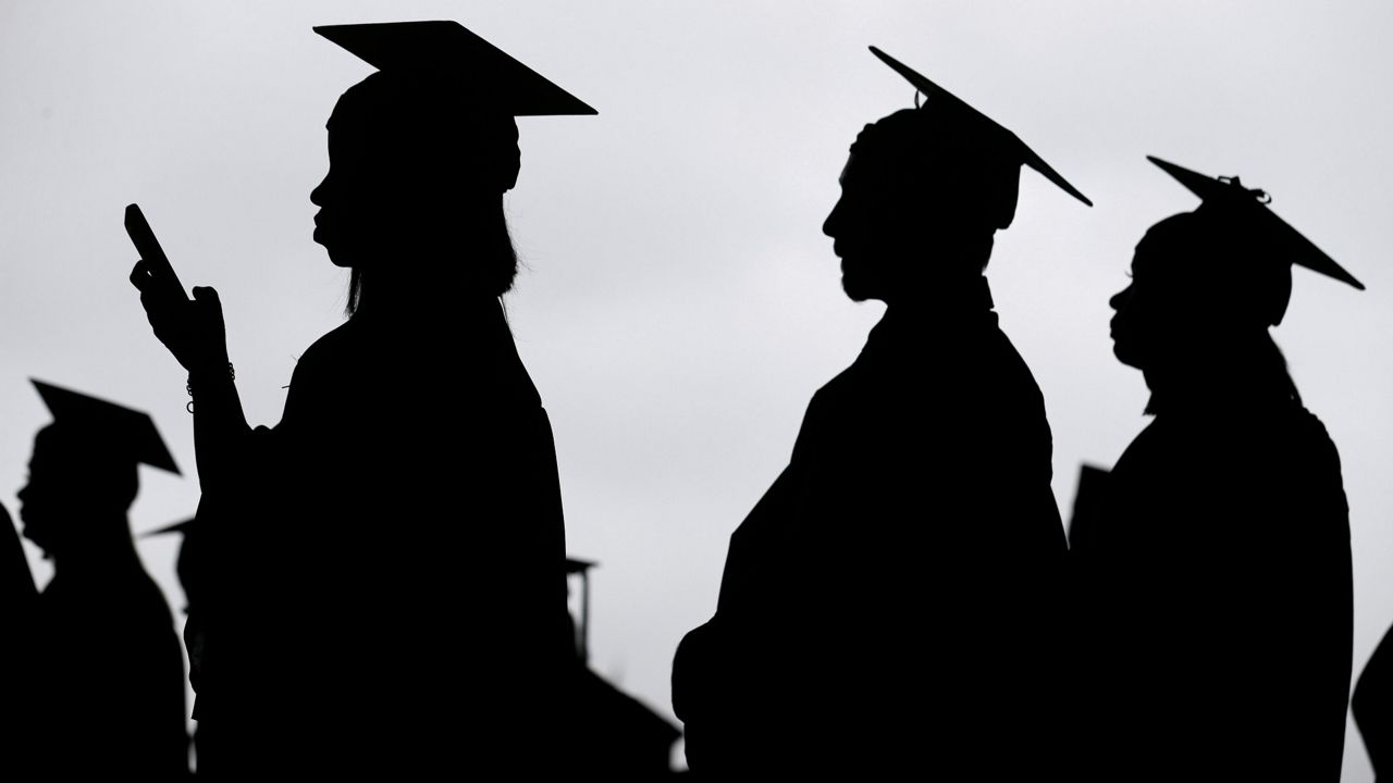 New graduates line up before the start of a community college commencement in East Rutherford, N.J., on May 17, 2018. (AP Photo/Seth Wenig, File)