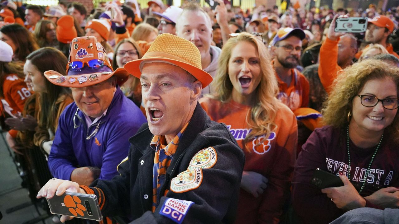 Clemson fans cheer on the Tigers as they arrive at Williams-Brice Stadium before an NCAA college football game against South Carolina Saturday, Nov. 27, 2021, in Columbia, S.C. (AP Photo/Sean Rayford, File)