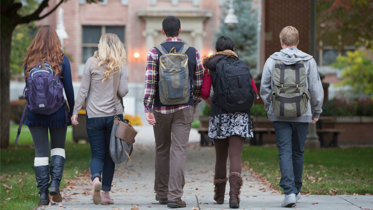 College students walking on campus (Getty Images)