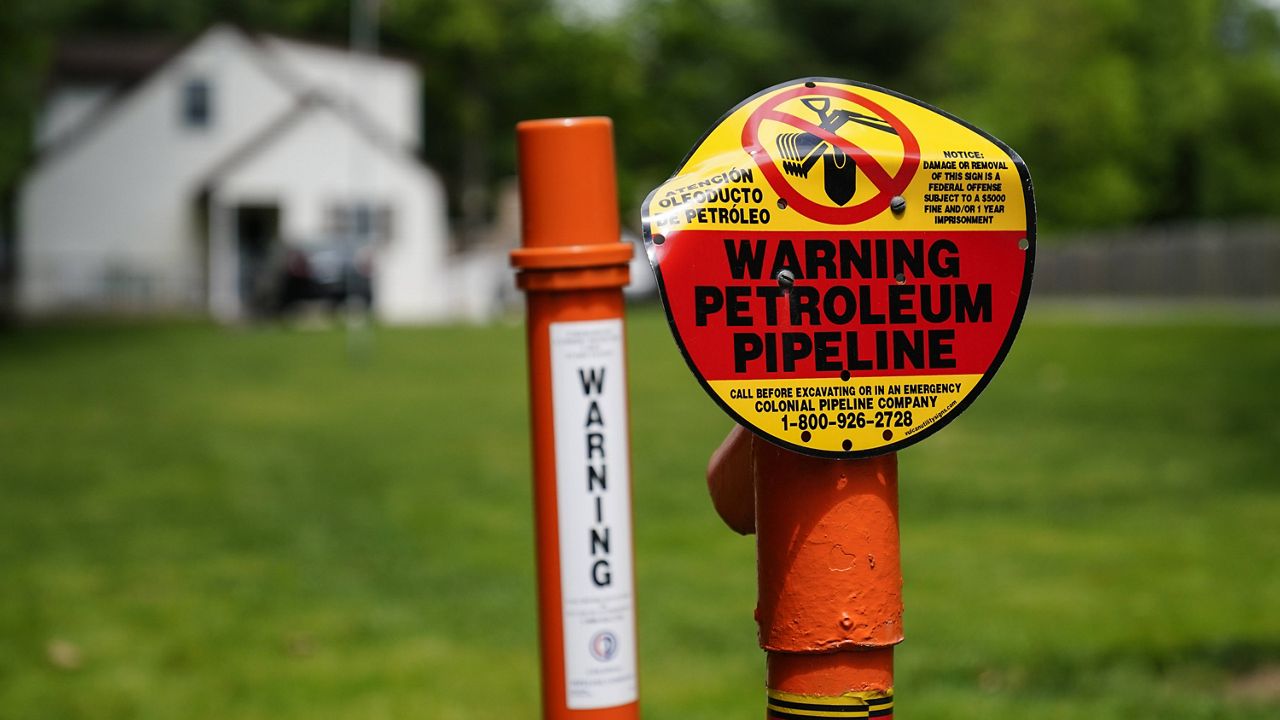 A warning sign is posted along the path of the Colonial Pipeline in Garnet Valley, Pa., on Monday. (AP Photo/Matt Rourke)