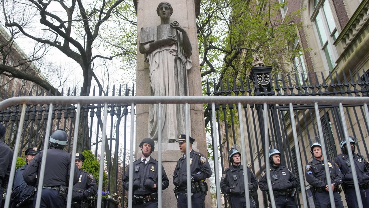 New York City police in riot gear stand guard outside the Columbia University campus after clearing the campus of protesters, April 18, 2024, in New York. (AP Photo/Mary Altaffer, File)