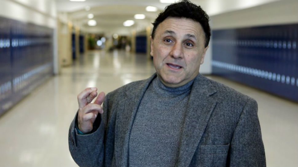 FILE - In this April 18, 2009 file photo Columbine High School Principal Frank DeAngelis crosses his fingers wishing that everything goes well with the School’s Prom as he talks with reporters in the hallway at the school near Littleton, Colo. Following school shootings like the massacre at Marjory Stoneman Douglas High, administrators reach out to the former Columbine High principal. There is no book to teach what he learned after gunmen killed 12 of his students and a teacher in 1999. (AP Photo/Ed Andrieski)