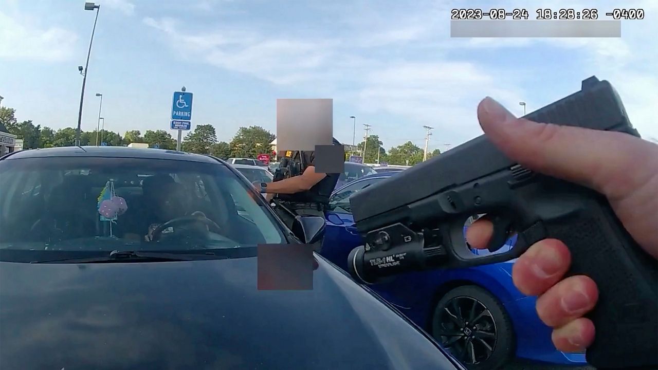 This still image from bodycam video released by the Blendon Township Police on Friday, Sept. 1, 2023, shows an officer pointing his gun at Ta'Kiya Young moments before shooting her through the windshield outside a grocery store in Blendon Township, Ohio, a suburb of Columbus, on Aug. 24. The video was pixelated by the source. (Blendon Township Police via AP, File)