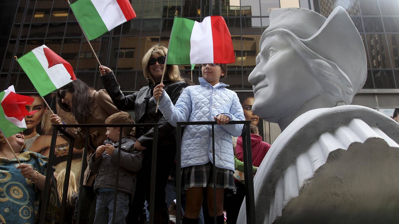 In this Oct. 8, 2012, file photo, people ride on a float with a large bust of Christopher Columbus during the Columbus Day parade in New York. (AP Photo/Seth Wenig, File) 