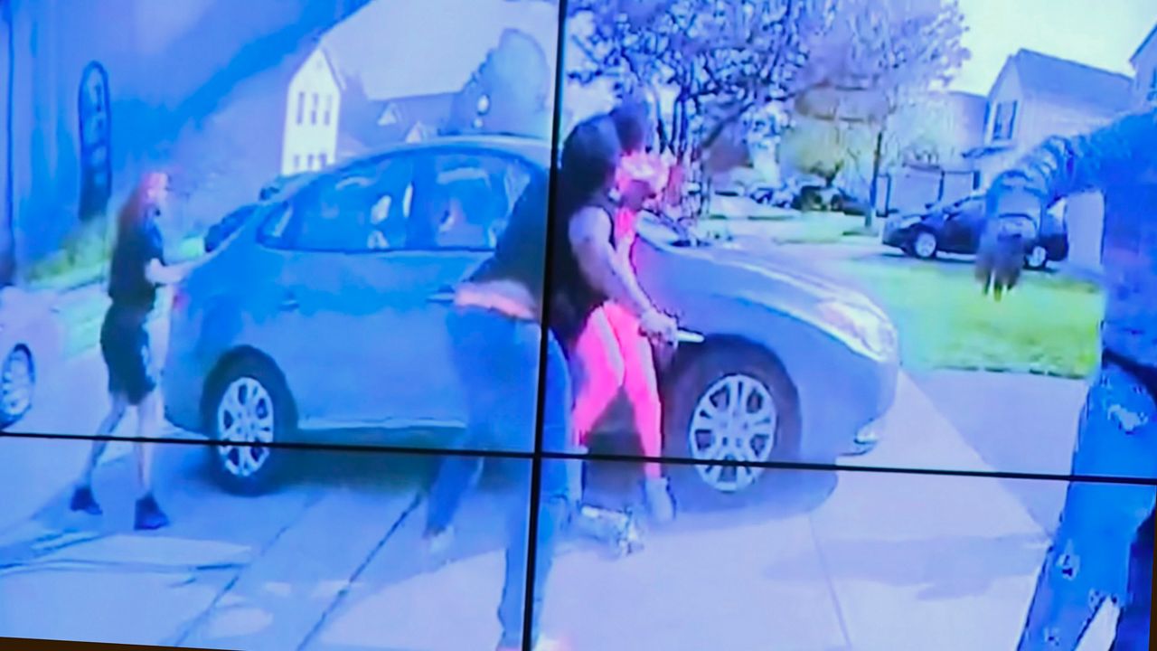 In an image from police bodycam video that the Columbus Police Department played during a news conference Tuesday night, April 20, 2021, a teenage girl, foreground, appears to wield a knife during an altercation before being shot by a police officer Tuesday, April 20, 2021, in Columbus, Ohio. (Columbus Police Department via WSYX-TV via AP)