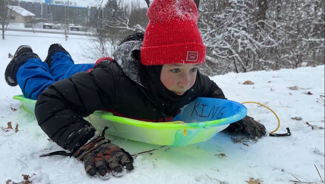 Downhill slide: Families enjoy snow day sledding