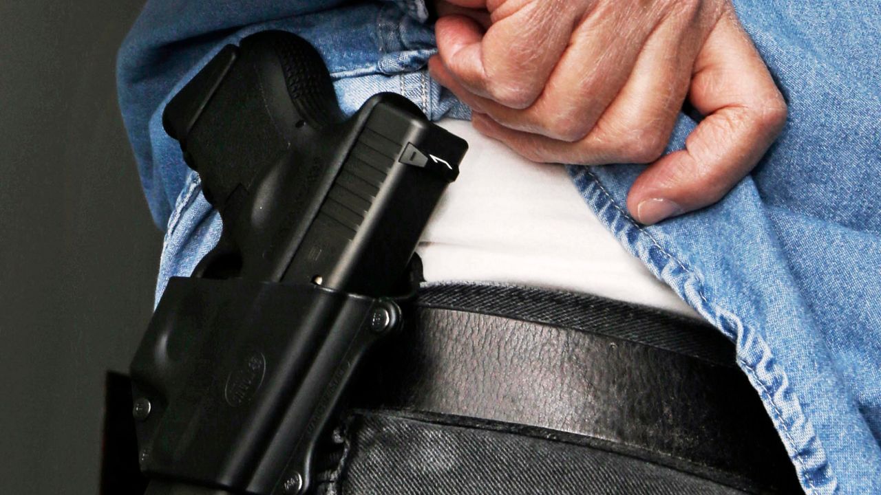 FILE - In this Feb. 27, 2013 file photo Hank Johnson displays his handgun, in Springboro, Ohio. Dealing a blow to gun supporters, a federal appeals court ruled Thursday, June 9, 2016, that Americans do not have a constitutional right to carry concealed weapons in public.  (AP Photo/Al Behrman, File)