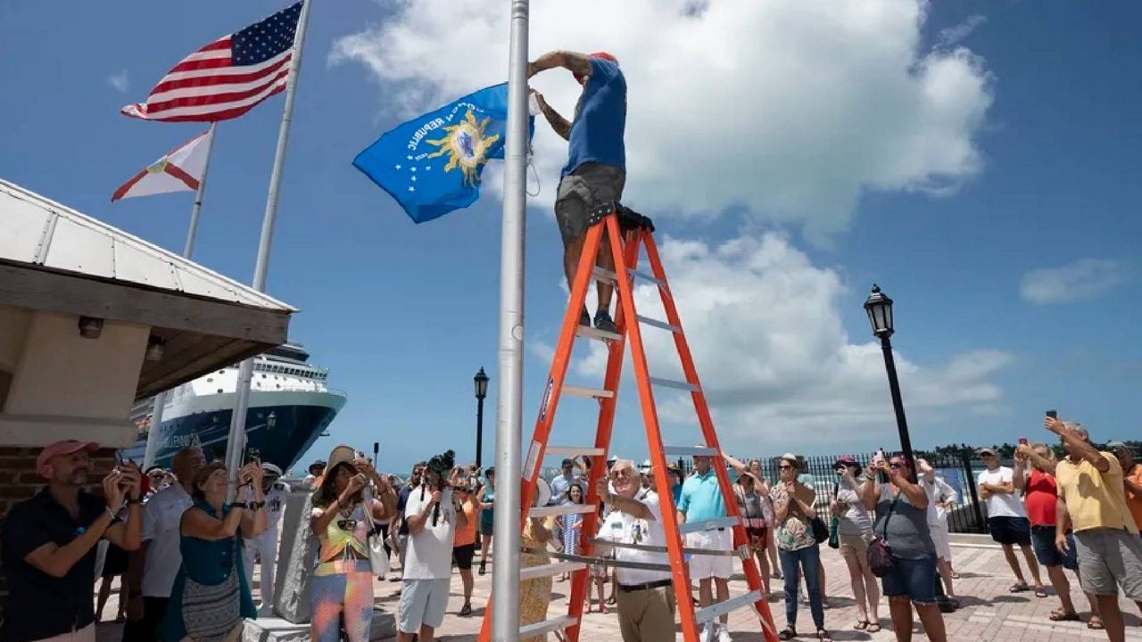 Paul Menta hoists a Conch Republic flag to formally begin the 10-day Conch Republic Independence Celebration marking the 40th anniversary of Key West's April 23, 1982, mock secession from the United States following the U.S. Border Patrol's sudden establishment of a roadblock at the top of the Florida Keys Overseas Highway. The roadblock eventually faded away, but the awareness of the Conch Republic remains. (Rob O' Neal/AP)