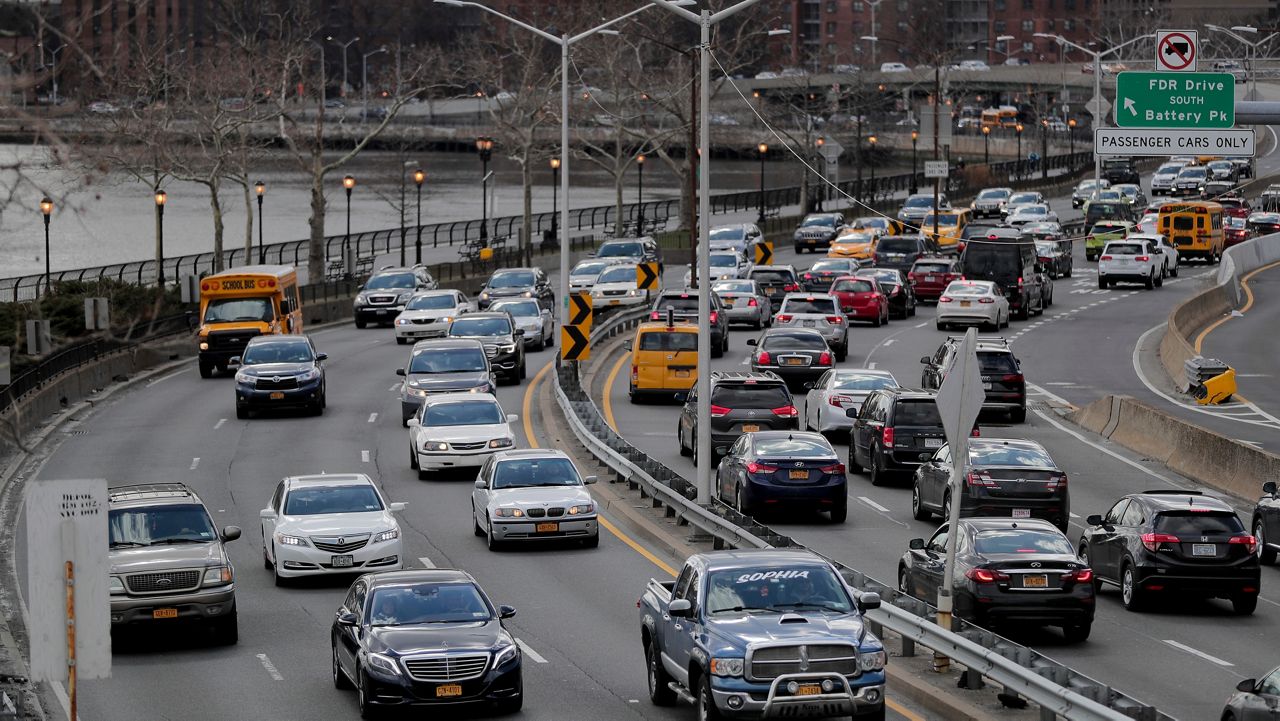 Motorists move along FDR Drive near 102nd Street, Friday, March 16, 2018, in New York. (AP Photo/Julie Jacobson)